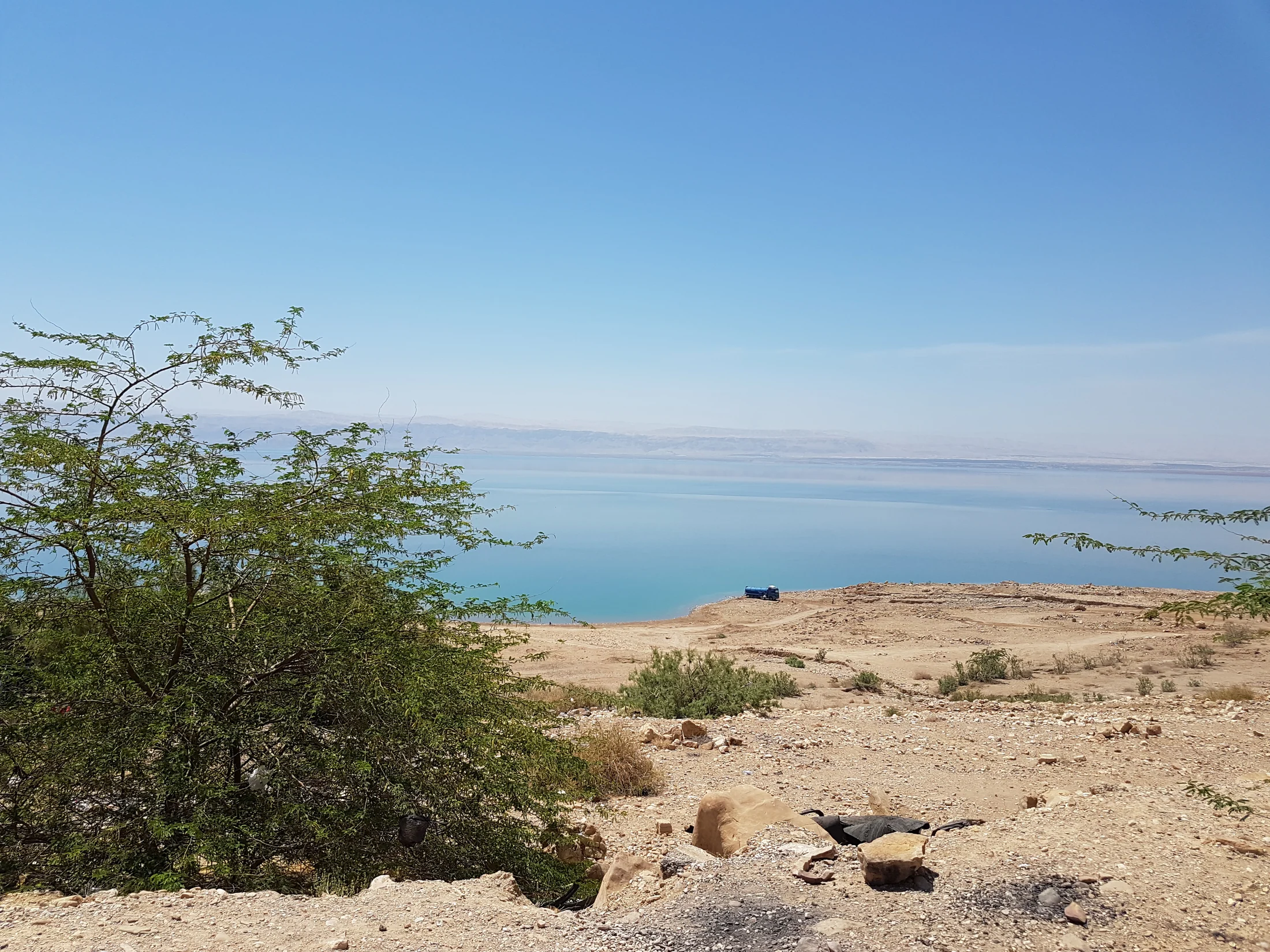 Turquoise water and desert shoreline seen from above the Dead Sea in Jordan