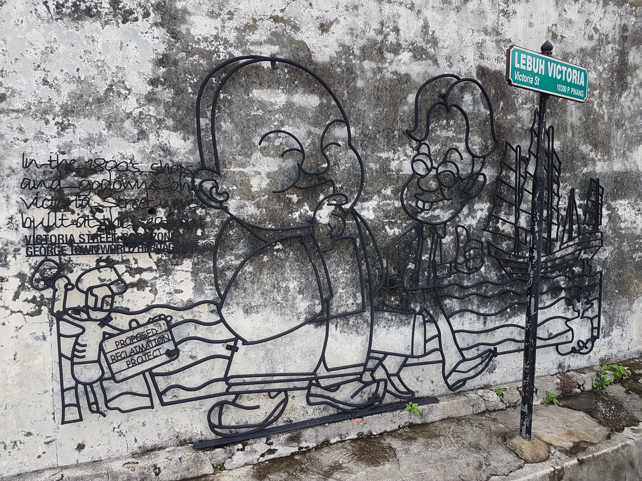 Steel street-art illustration on a weathered wall at Lebuh Victoria in George Town, Penang